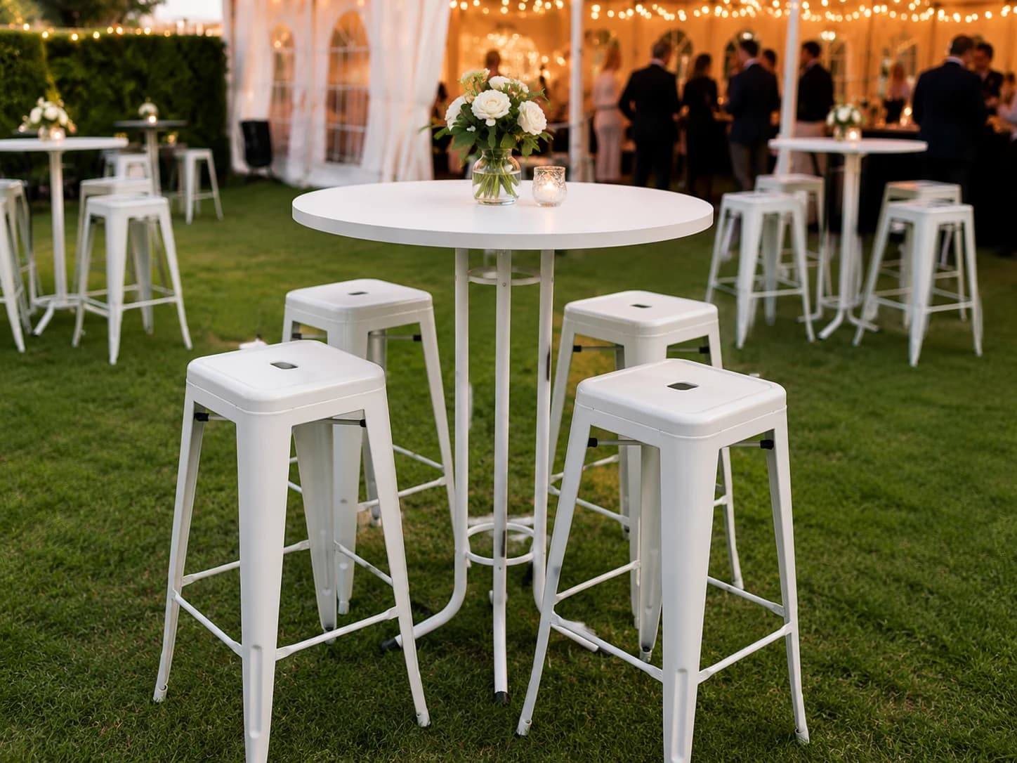 White cocktail-height bar tables for an event setup