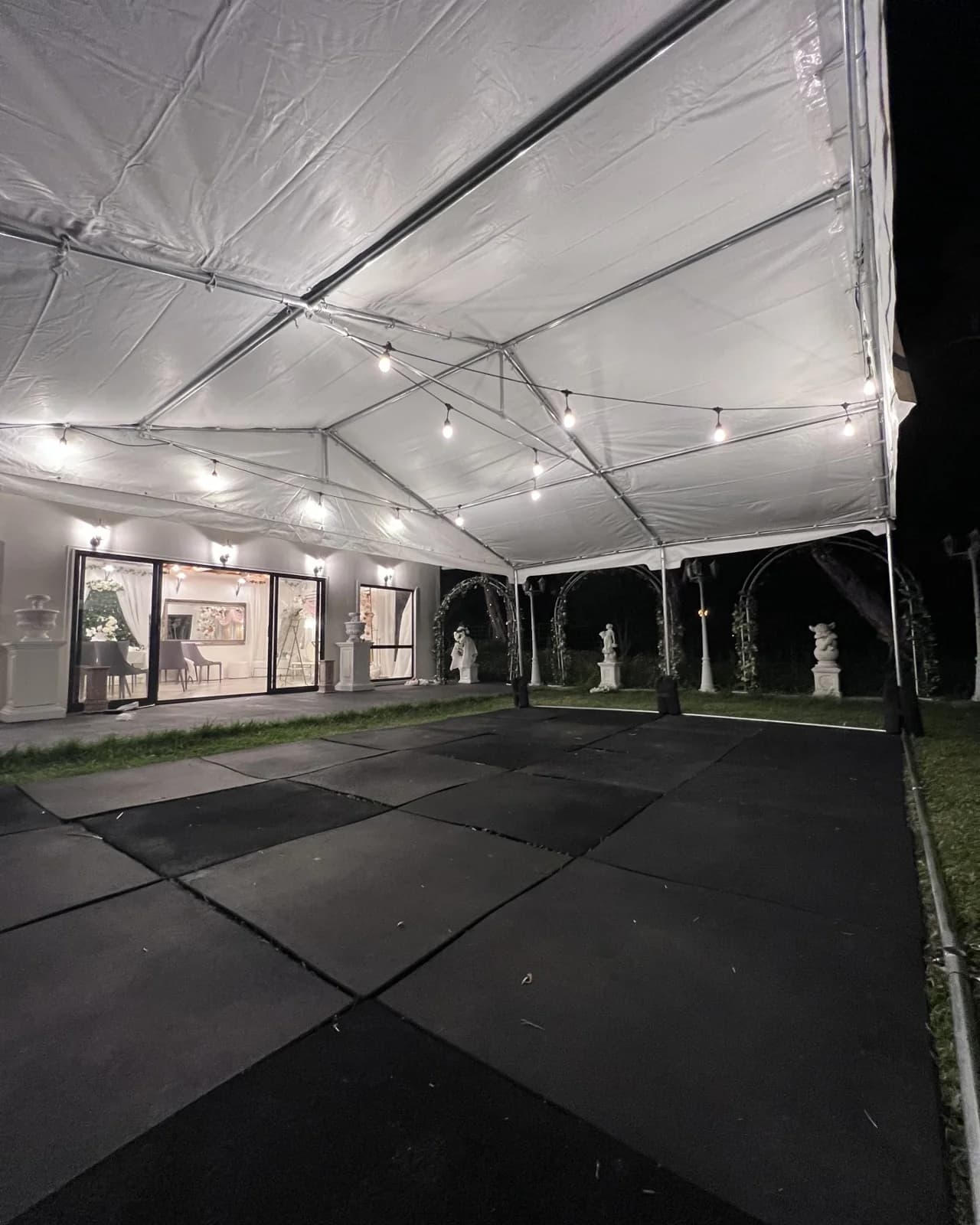 Black dance floor set inside a marquee for an evening event in Melbourne