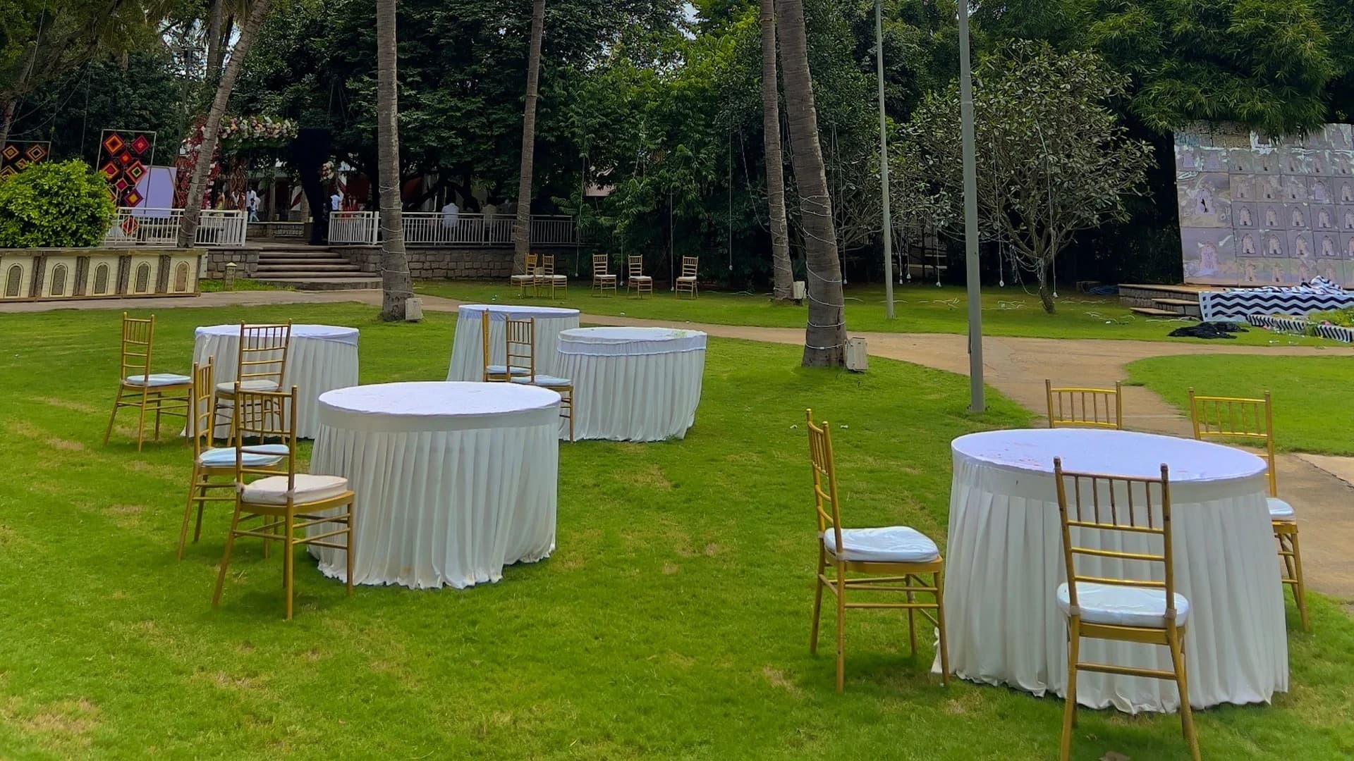 Round tables and white folding chairs arranged for a Melbourne event