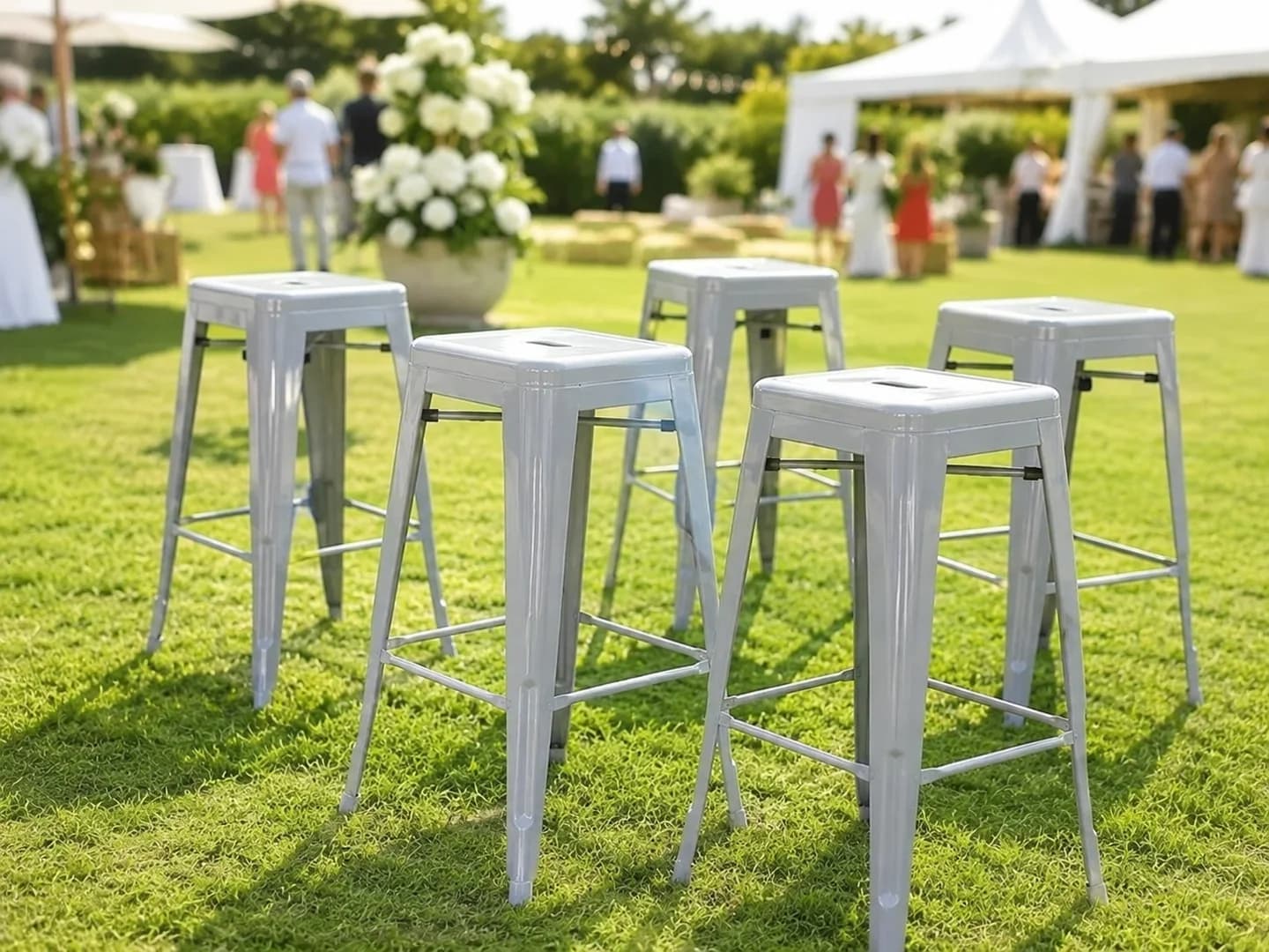 Grey metal bar stools arranged on grass for a daytime outdoor Melbourne event